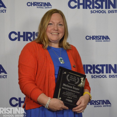 Photo of Melissa Soyer Teacher of The Year for West Park Place ES holding award